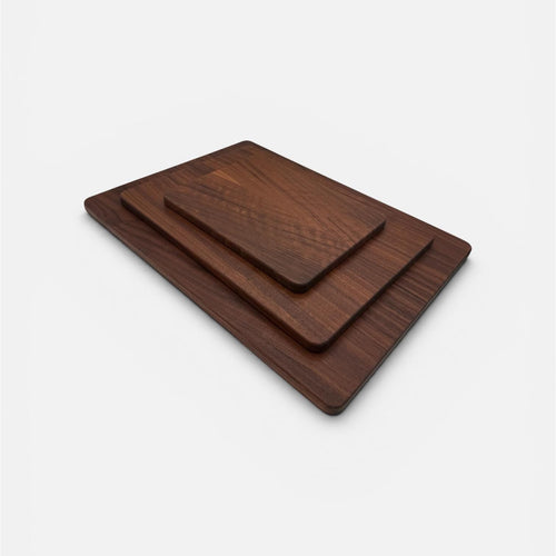 Set of three wooden cutting boards on a white background