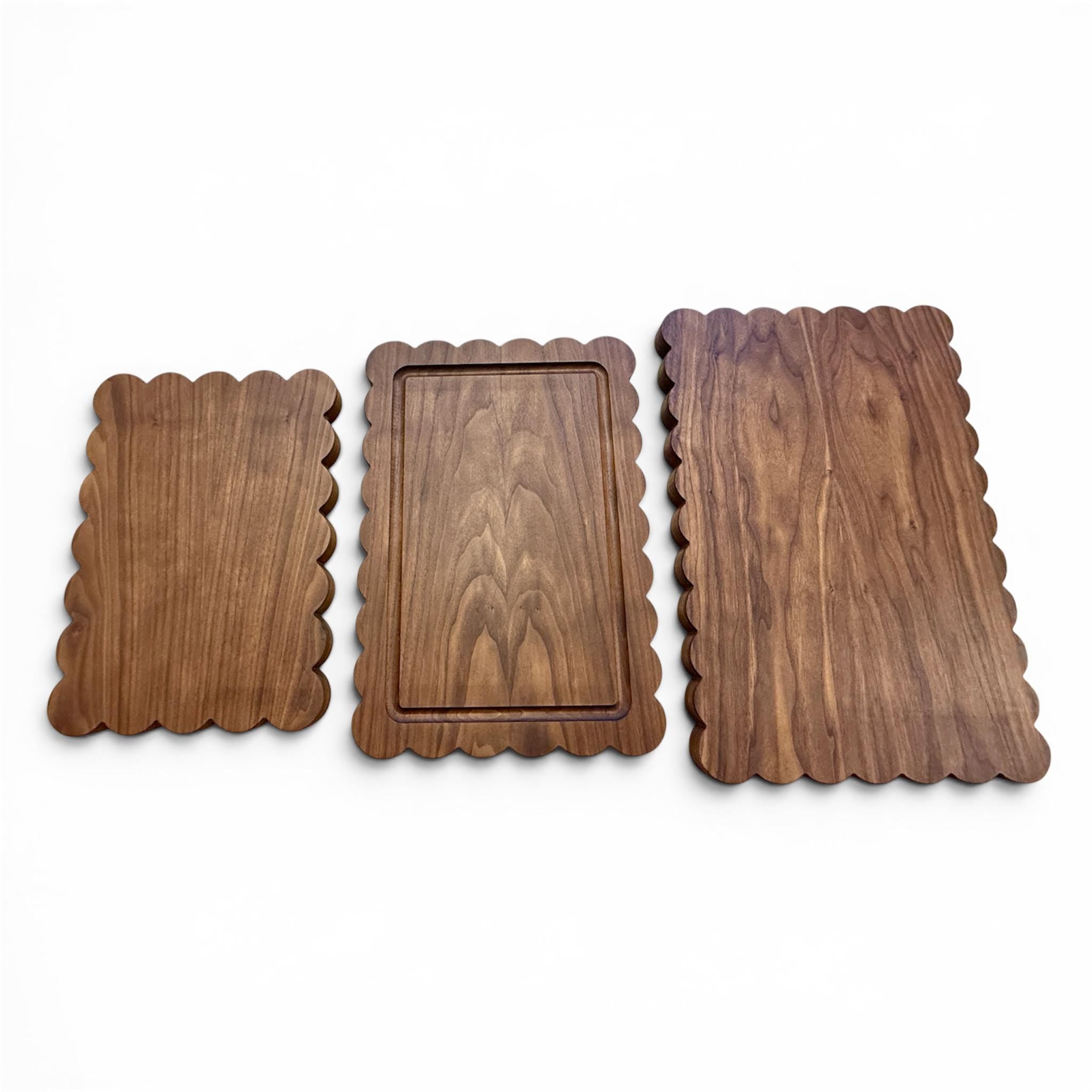 Three wooden boards with scalloped edges on a white background