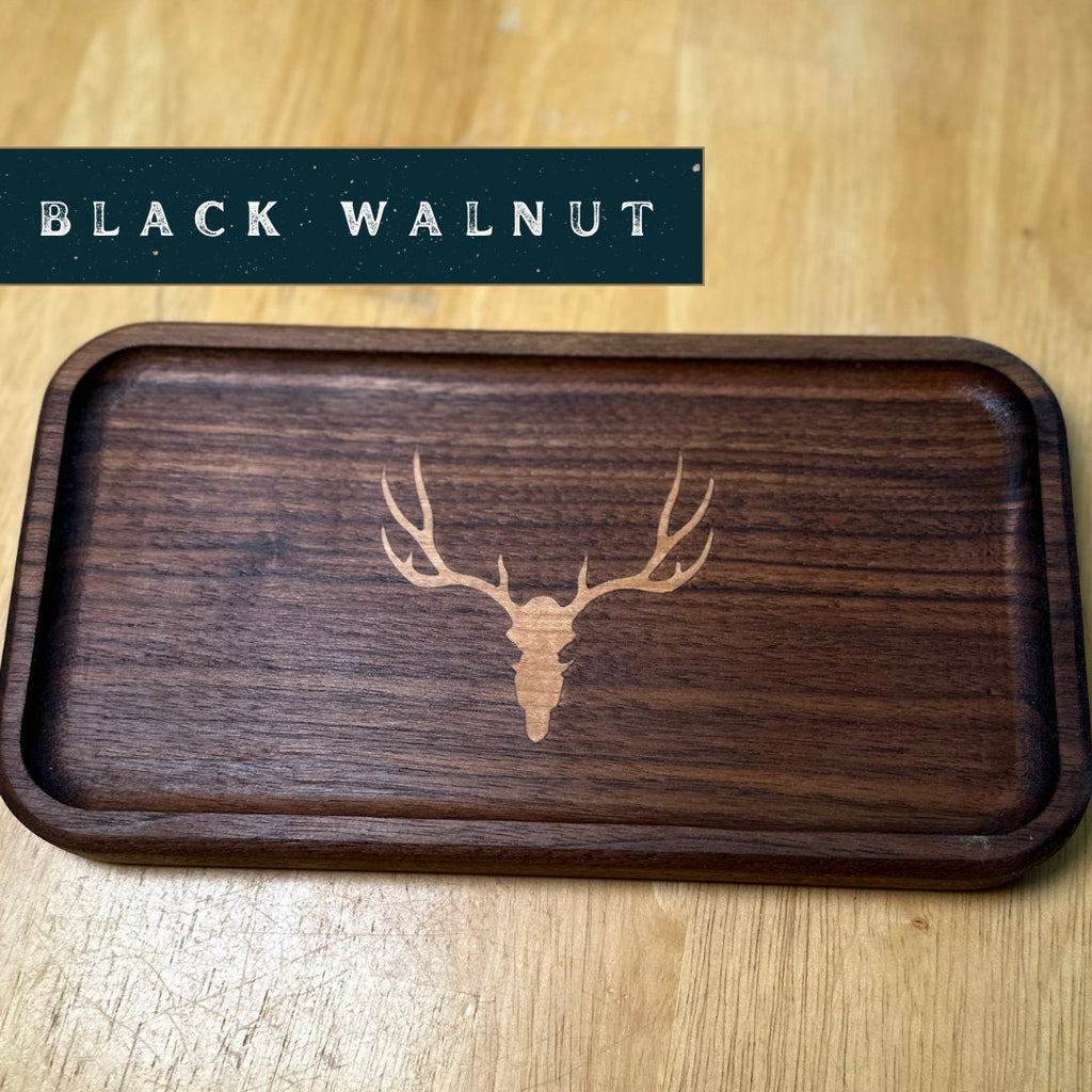 Wooden tray with deer head engraving on a wooden surface, labeled 'Black Walnut'.