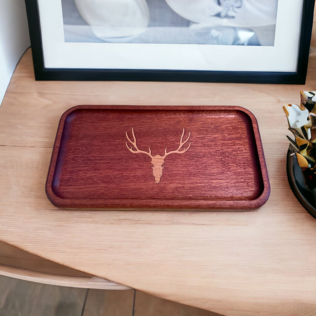 Wooden tray with deer head design on a wooden surface