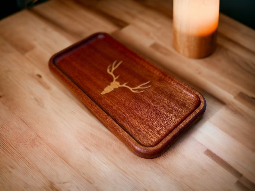 Wooden phone case with deer engraving on a wooden surface