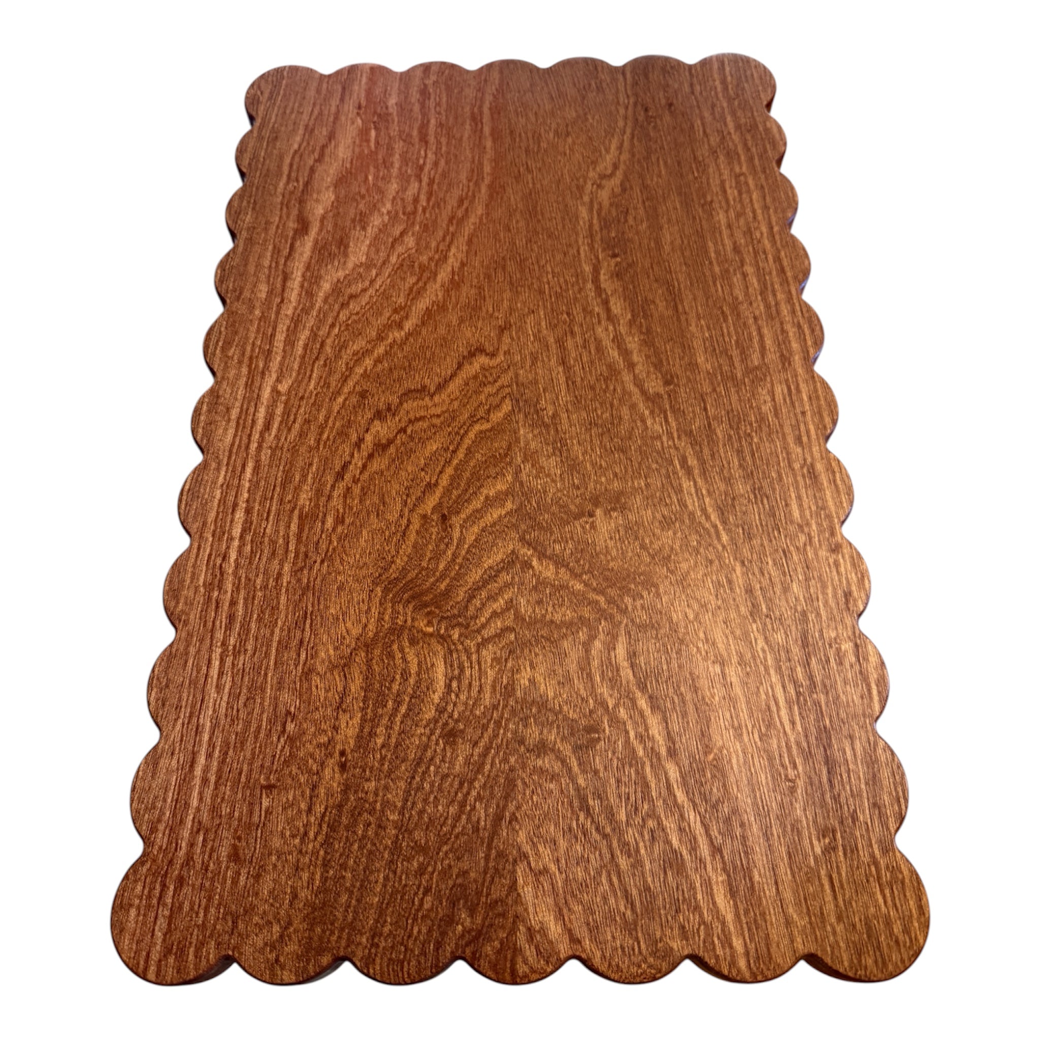 Scalloped mahogany cutting board on white background 