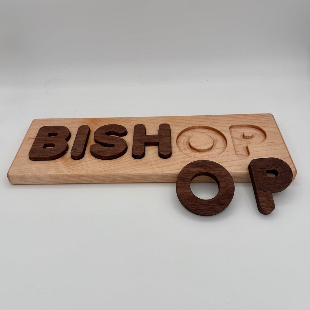 Wooden nameplate with 'BISHOP' engraved on a white background