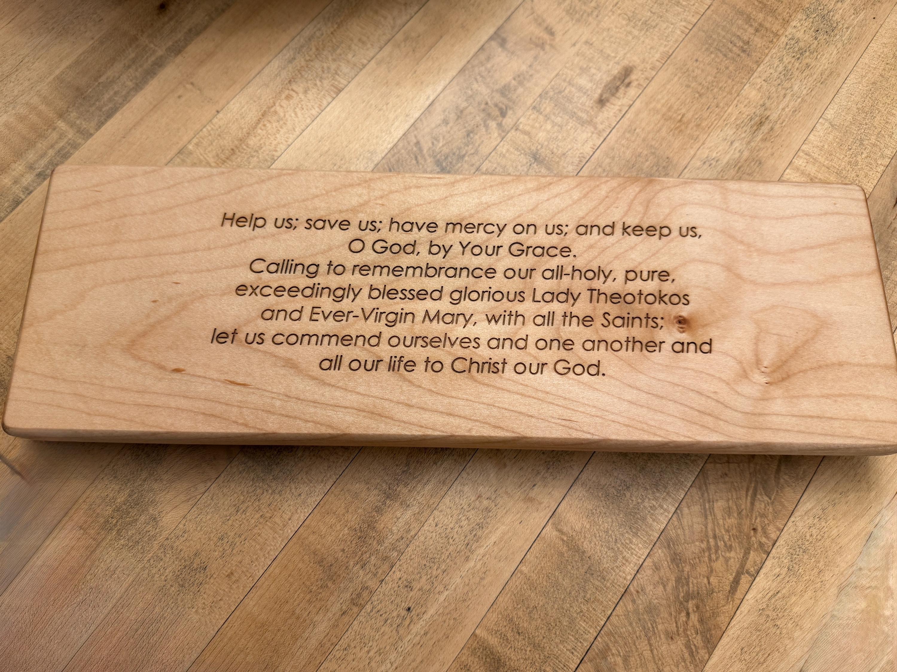 Wooden plaque with engraved text on a wooden table