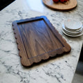 Wooden tray on a marble countertop with a blurred background