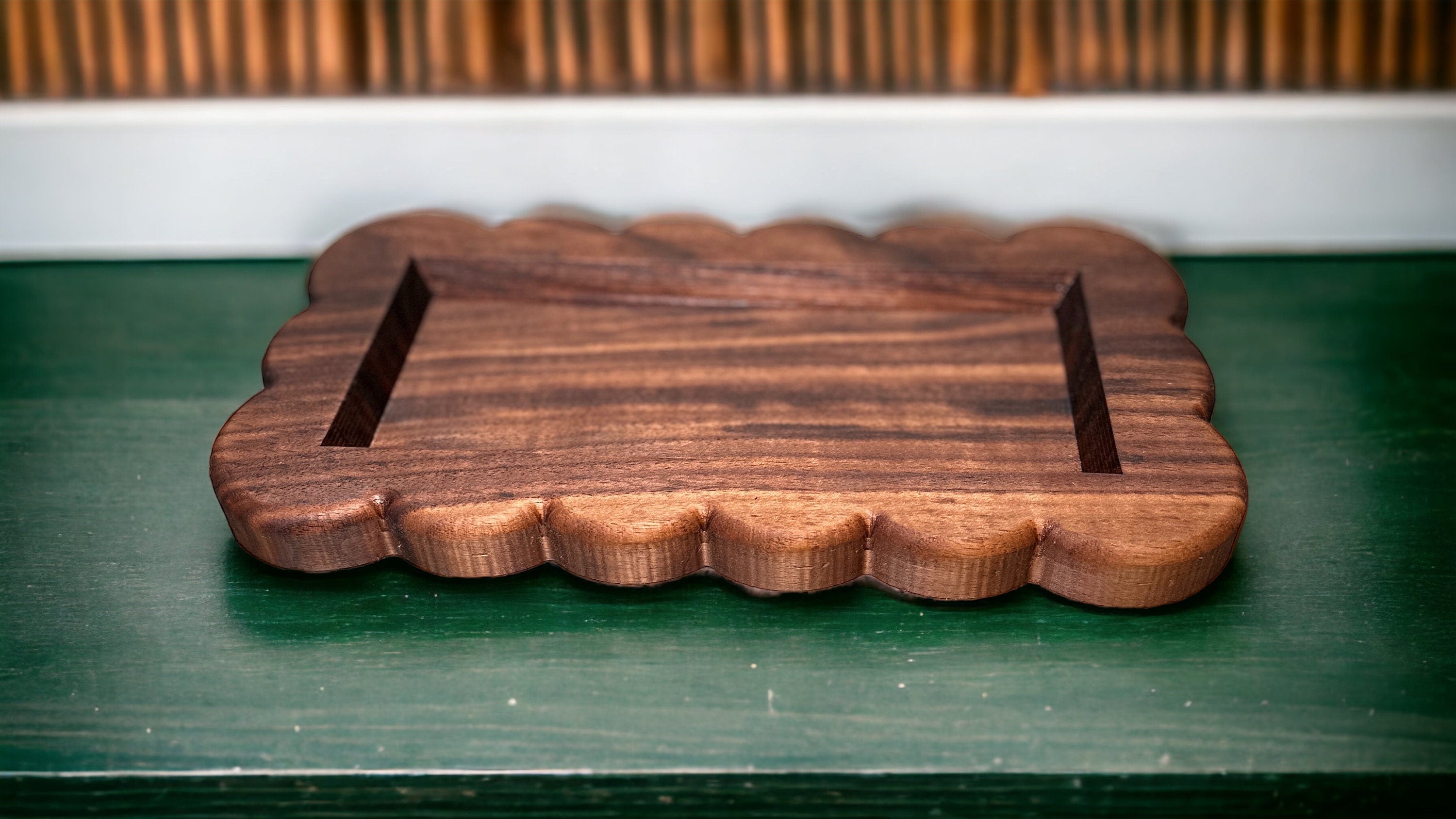 Small tray with scalloped edge on a green surface