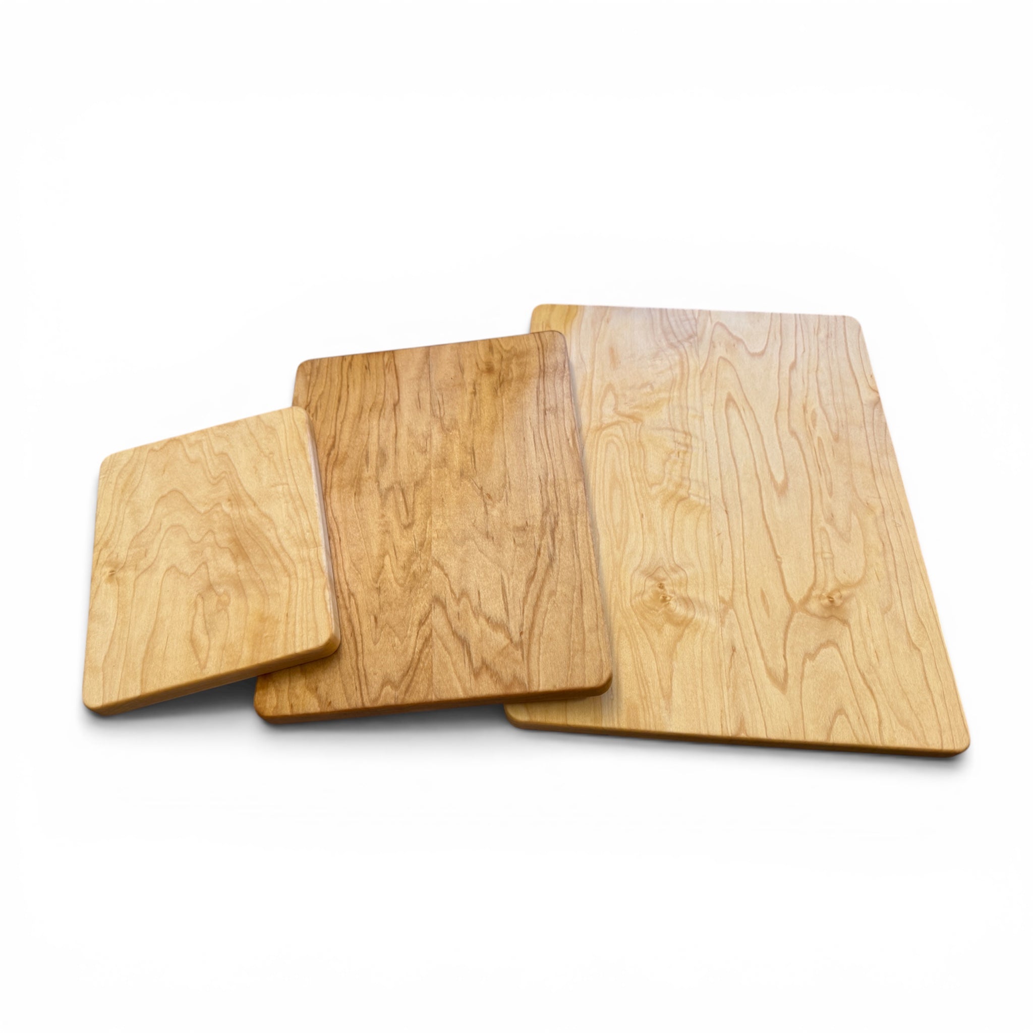 Three maple wood cutting boards of different sizes, arranged in a nested stack on a plain white background.