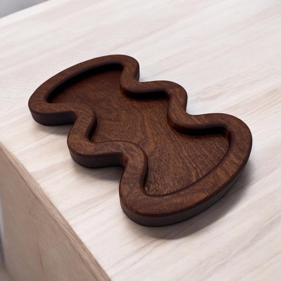 Wooden waavy tray on a light wooden surface